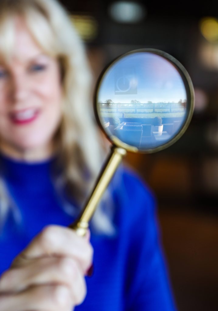 Rachel Ray looking through a magnifying glass